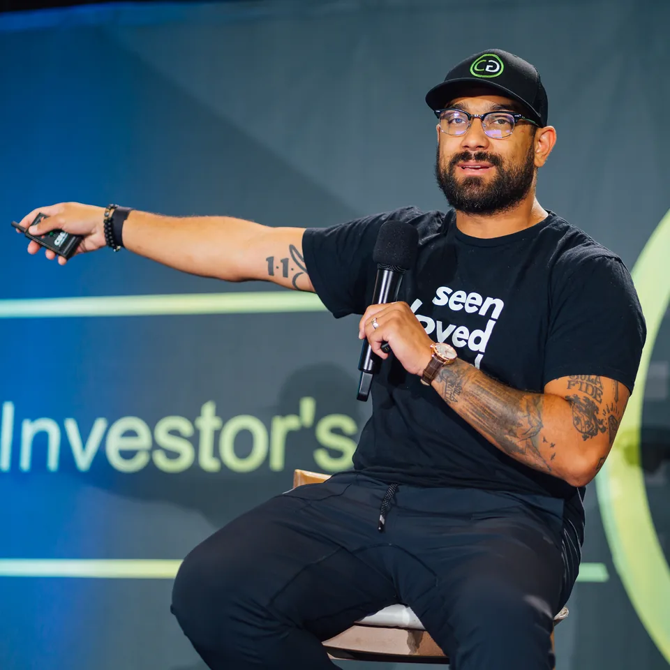 Devin Robinson, founder of ForesightCRM, speaking on stage at a Collective Genius real estate investor event